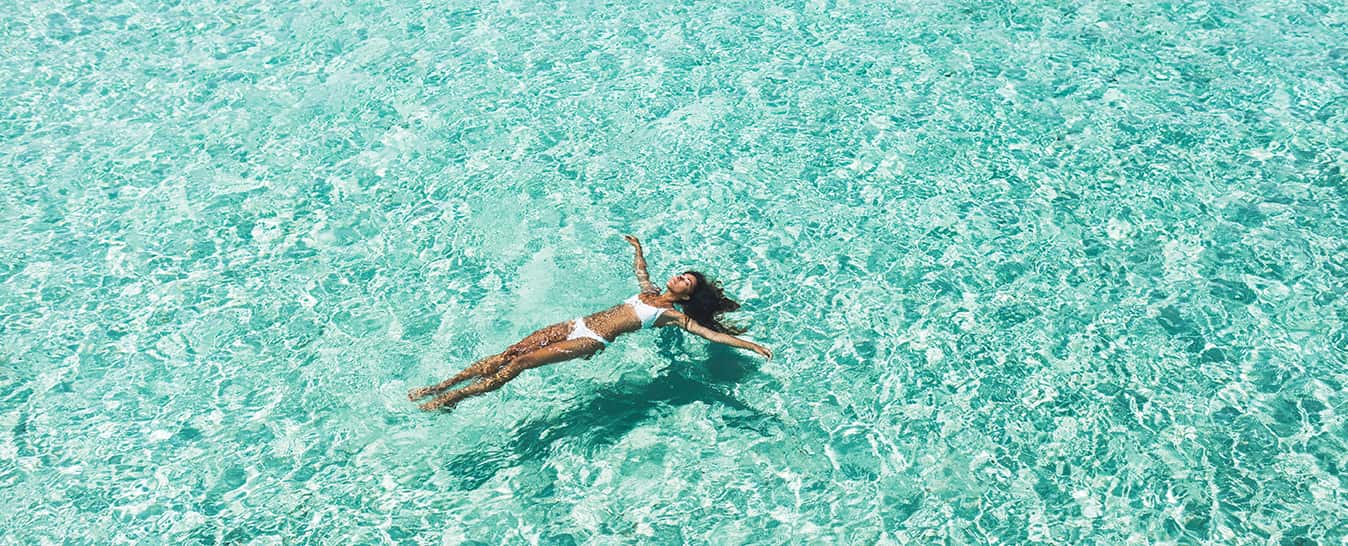 6 Women Floating In Blue Water